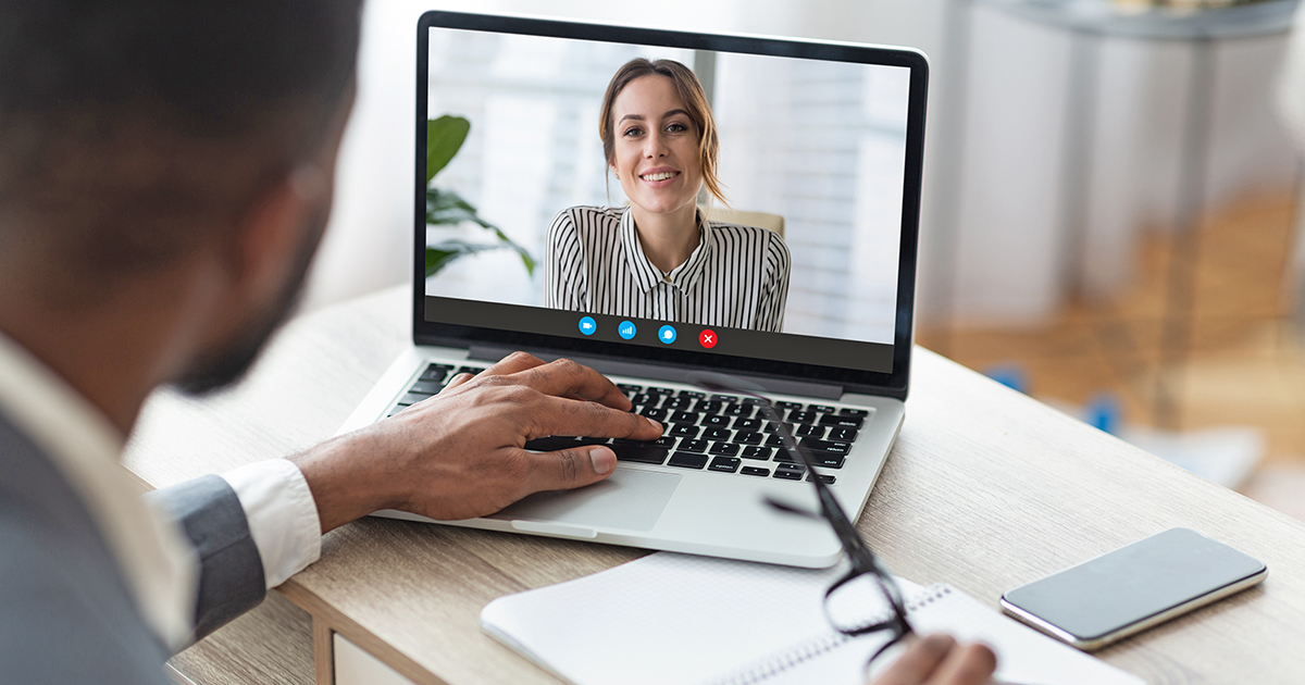 Online Meeting Concept. Back view of black male boss having video call discussion with his female colleague, copy space