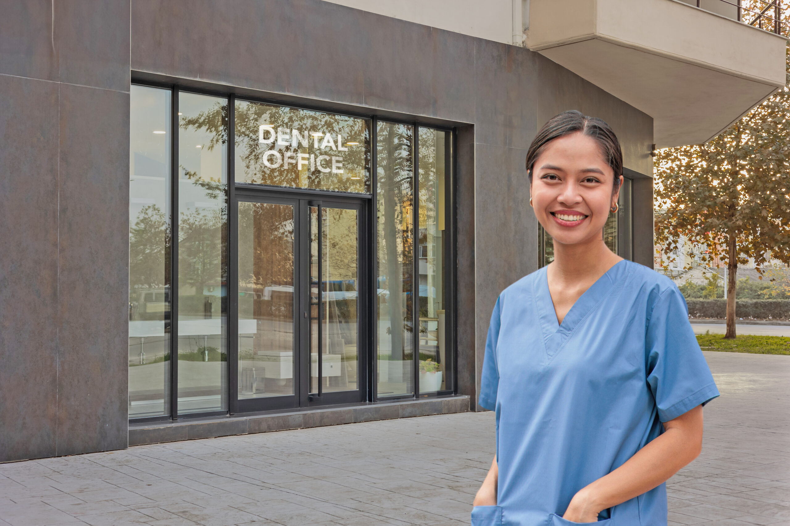Modern Veterinary Clinic with Brick Facade, Large Glass Windows, and Green Landscaping for Animal Healthcare Services