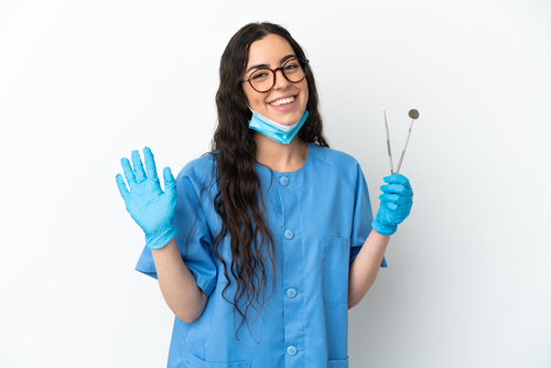Young,Woman,Dentist,Holding,Tools,Isolated,On,White,Background,Saluting
